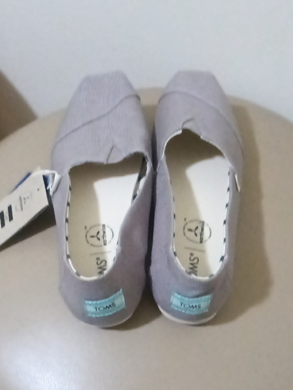 TOMS Kids Slip-On Moccasins in Light Gray with Blue Heel Tab